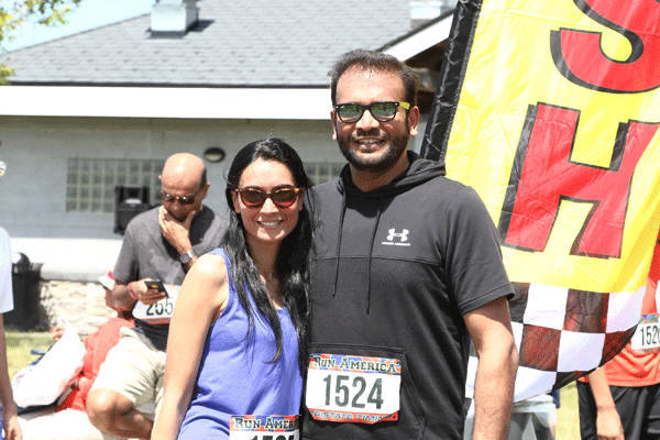 A pair of runners pose at the 5K finish line.