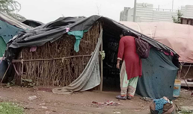 A village healthcare worker checking in on a woman whose baby was born with low birth weight, as part of the SNCU — special neonatal care unit — follow up program.