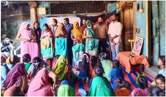 Volunteers and beneficiaries attend a sari library inauguration in Punadra Village.
