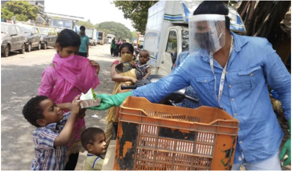 Children receive khichdi meals in Mumbai, Maharashtra. 