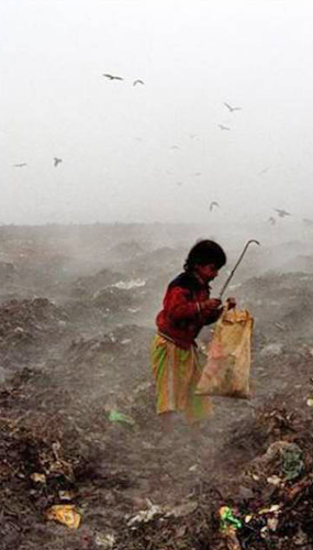 Child searching through dump site.