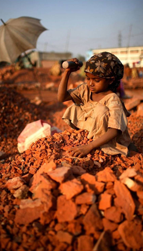 Young girl hitting rocks.